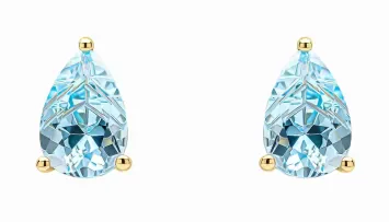 Boucles d'oreilles clous en or jaune 375 carats serties de topazes bleues naturelles.