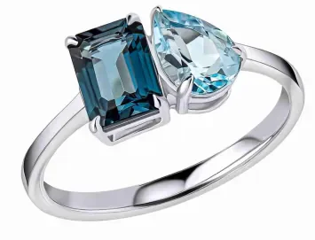 Bague pour femme en or blanc 375 massif sertie de topazes naturelles facettées aux nuances bleu marine et bleu ciel.